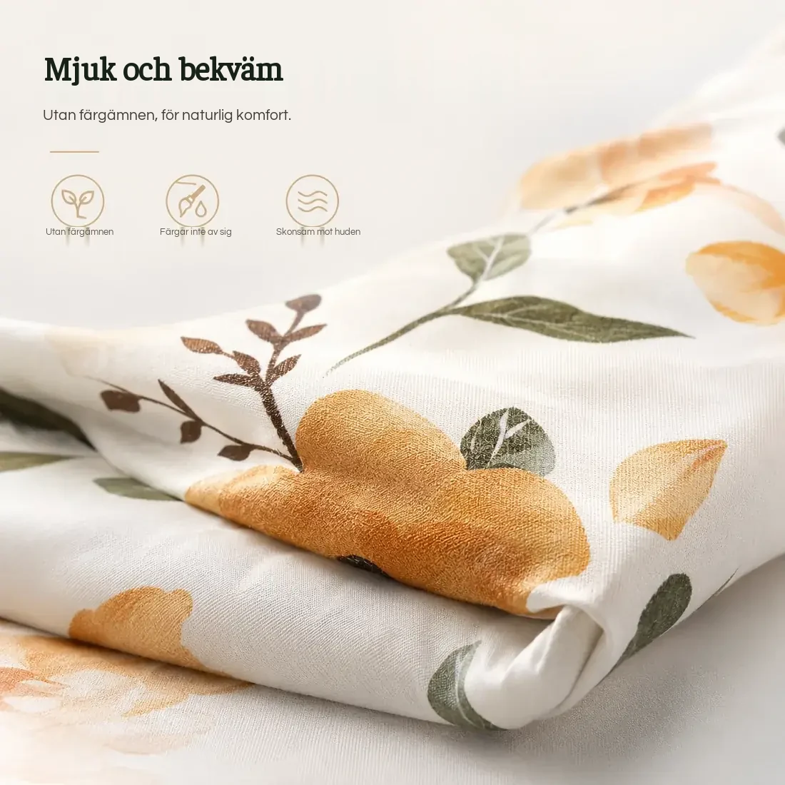 Närbild på amningskuddens tyg, blommönster i ockra och grönt, vikt om sig självt
